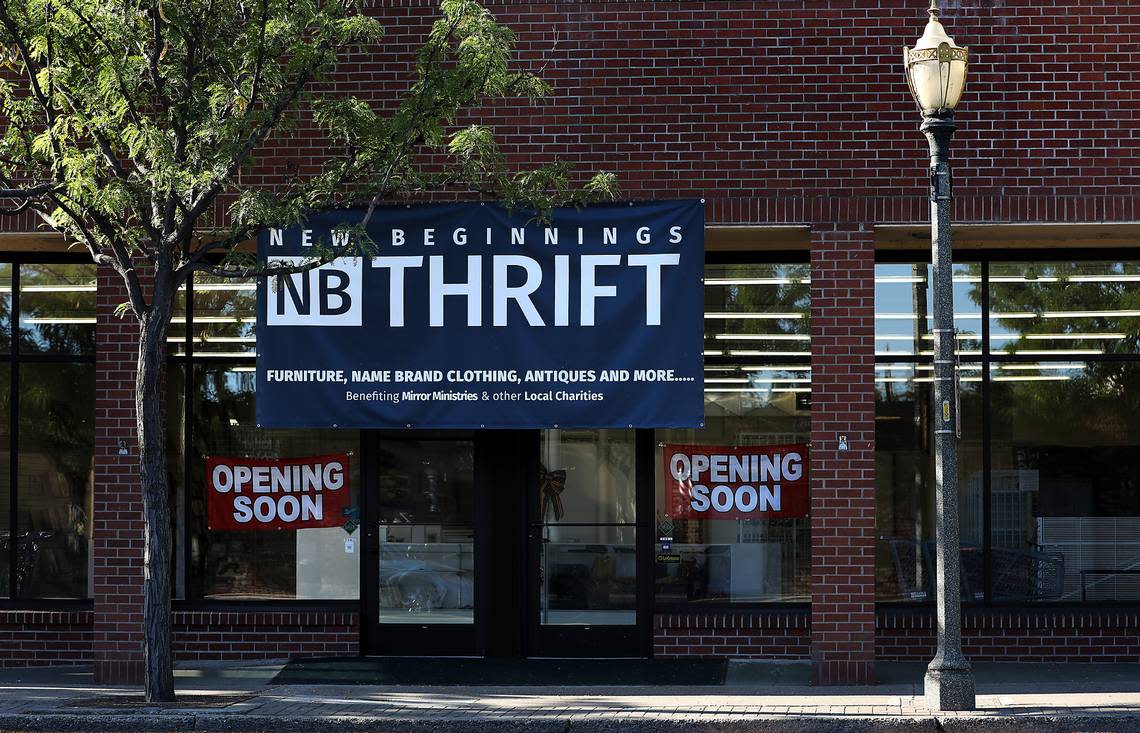 A banner hangs above the doorway to the former Basin Department Store announcing the pending opening of New Beginnings Thrift store in downtown Kennewick. The store will benefit Mirror Ministries and other local charities.