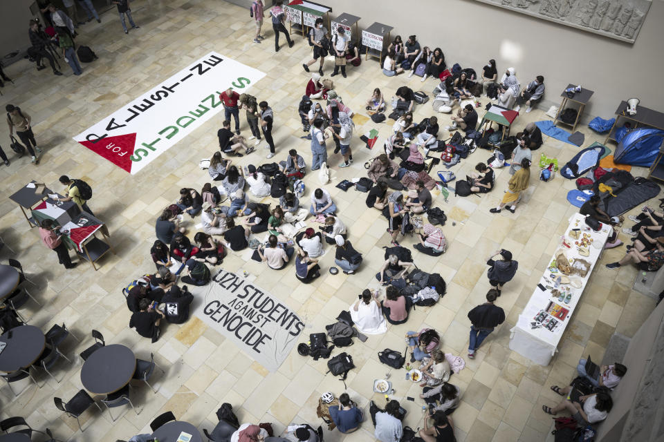 Pro-Palestinian demonstrators stage a protest in the entrance hall of the main building at the University of Zurich (UZH), in Zurich, Switzerland on Tuesday, May 14, 2024. (Ennio Leanza/Keystone via AP)