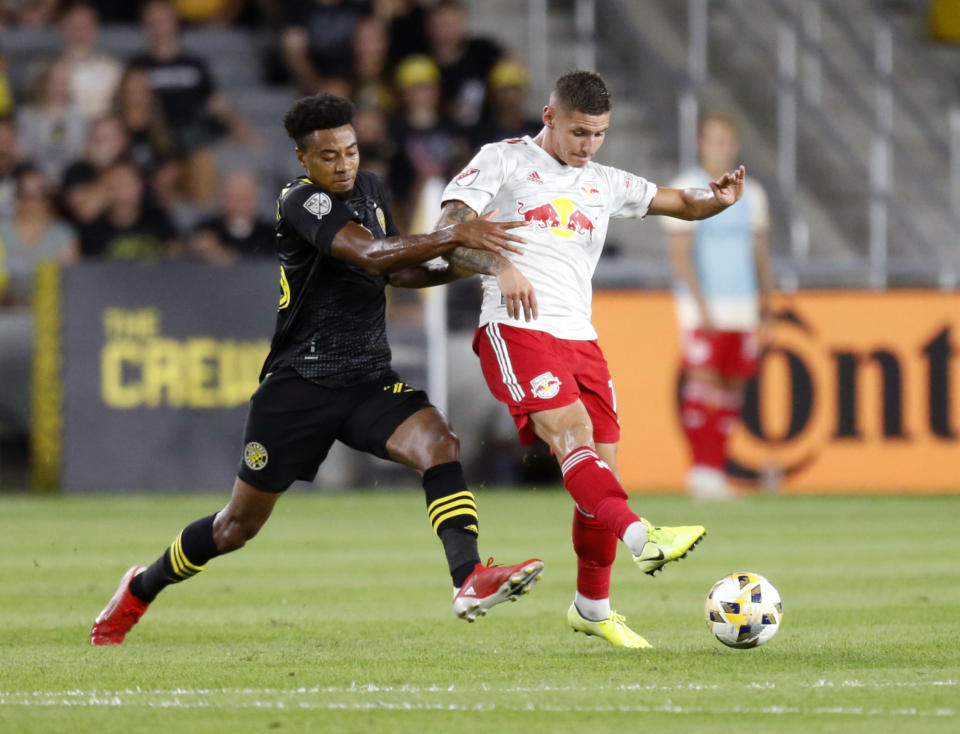 New York Red Bulls forward Patryk Klimala, right, passes in front of Columbus Crew defender Saad Abdul-Salaam during the first half of an MLS soccer match in Columbus, Ohio, Tuesday, Sept. 14, 2021. (AP Photo/Paul Vernon)