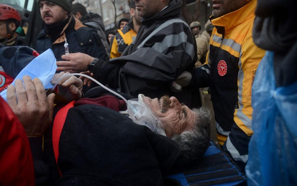 People pull a survivor from the rubble in Diyarbakir on February 6, 2023 - Ilyas Akengin/AFP