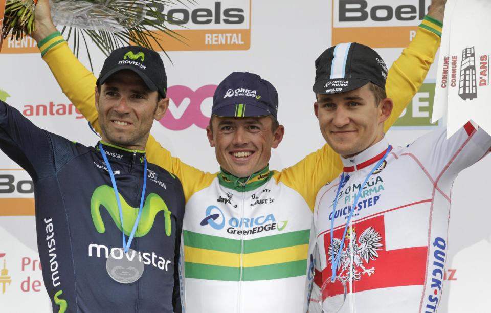 Australia's Simon Gerrans of the Orica Greenedge team, center, celebrates on the podium after winning the 100th edition of the Belgian cycling classic and UCI World Tour race Liege-Bastogne-Liege with Spain's second placed Alejandro Valverde of the Movistar team, left, and third placed Poland's Michal Kwiatowski of the Omega Pharma team, in Ans, Belgium, Sunday, April 27, 2014. (AP Photo/Yves Logghe)