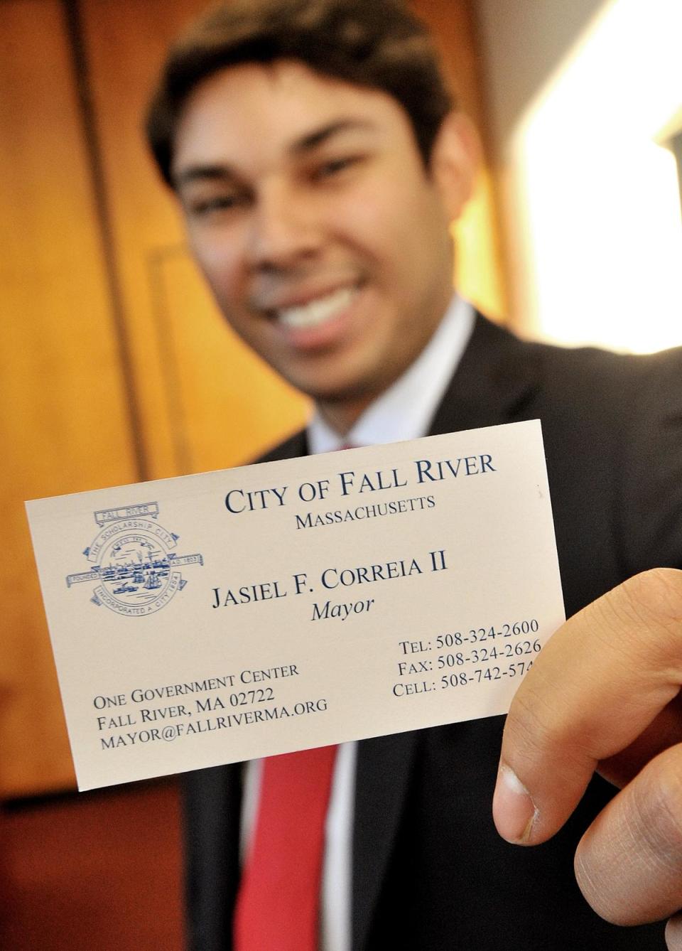 Jasiel Correia II shows off his new business card on his first day as mayor of Fall River, in January 2016.