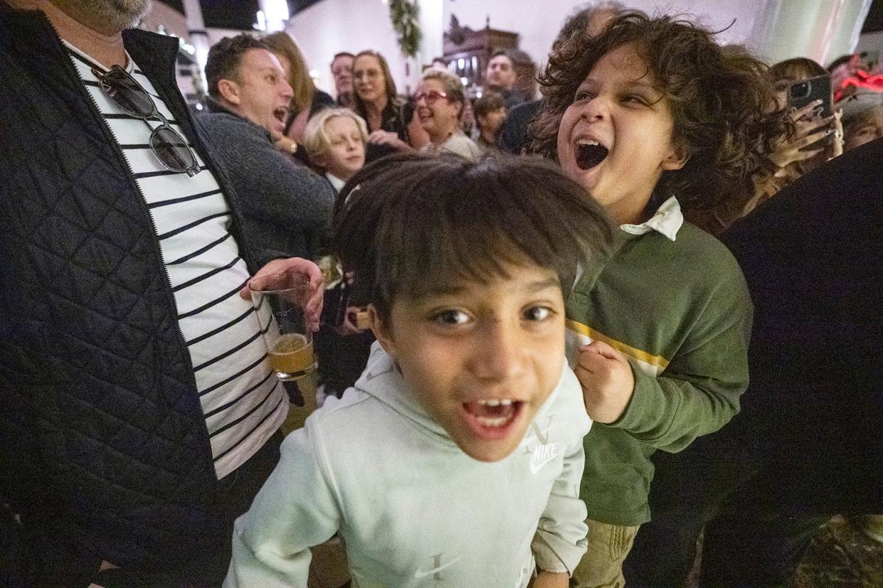 Isaiah Ximenez, 9, and Michael Ximenez, 10, react to Santa's arrival at the Driskill Hotel on Dec. 1. The Ramirez-Ximenez family was able to spend the night in a Driskill suite and light the hotel's Christmas tree during its tree lighting ceremony. People bought ornaments, candles and cookies at the tree lighting to raise $3,117 for Season for Caring.