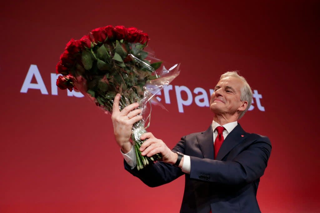 Labour leader Jonas Gahr Store holds a bouquet of red roses after the results of the election (NTB/AFP via Getty Images)