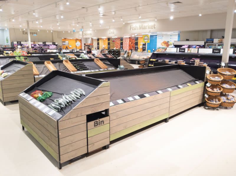 Pictured are empty fruit and vegetable shelves in an Australian supermarket after coronavirus panic buying.