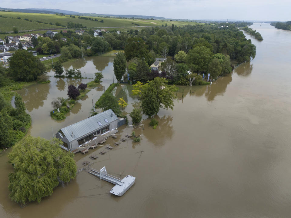 The Rhine river overflowed its banks in Hattenheim, Germany, Monday, June 3, 2024. The death toll in floods across a large part of southern Germany rose to two on Monday as the body of a missing woman was found. Chancellor Olaf Scholz visited the flooded region and officials warned that water levels could rise further in some areas. (Boris Roessler/dpa via AP)