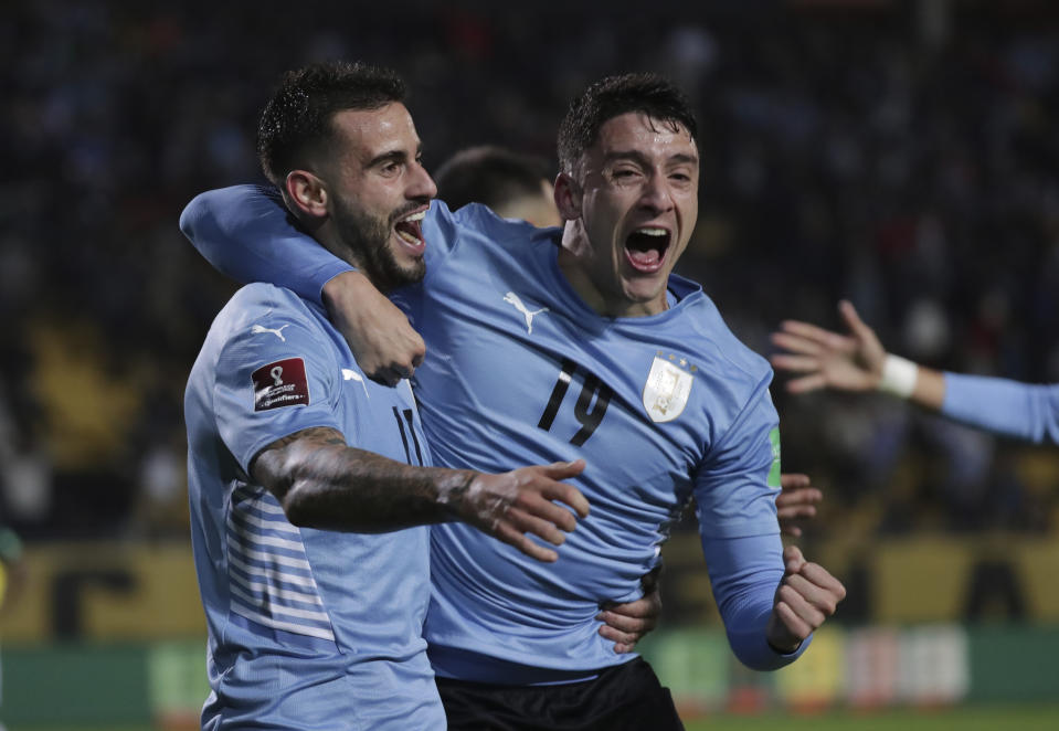 Uruguay's Gaston Pereiro, left, celebrates with teammate Uruguay's Sebastian Coates after scoring his side's opening goal against Ecuador during a qualifying soccer match for the FIFA World Cup Qatar 2022 at Campeon del Siglo stadium in Montevideo, Uruguay, Thursday, Sept.9, 2021. (Raul Martinez/Pool via AP)