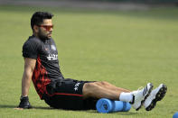 India cricket team captain Virat Kohli stretches during a practice session ahead of the Asia Cup tournament in Dhaka, Bangladesh, Monday, Feb. 24, 2014. Pakistan plays Sri Lanka in the opening match of the five nation one day cricket event that begins Tuesday. (AP Photo/A.M. Ahad)