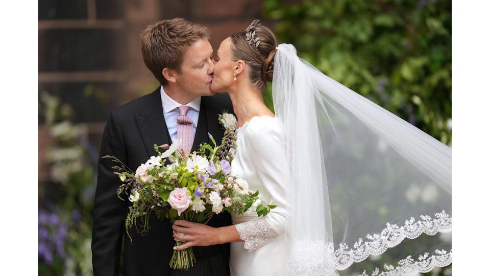 Hugh and Olivia kiss after their wedding