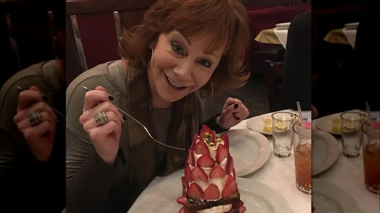 Reba eating slice of strawberry cake 