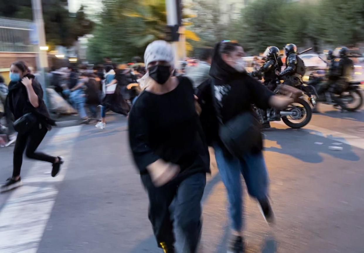 A protest for Mahsa Amini, who died after being arrested by Iran's morality police for allegedly not complying with dress code laws, in Tehran on Sept. 19, 2022. <a href="https://www.gettyimages.com/detail/news-photo/people-gather-during-a-protest-for-mahsa-amini-who-died-news-photo/1243377148?adppopup=true" rel="nofollow noopener" target="_blank" data-ylk="slk:Stringer/Anadolu Agency via Getty Images;elm:context_link;itc:0;sec:content-canvas" class="link ">Stringer/Anadolu Agency via Getty Images</a>