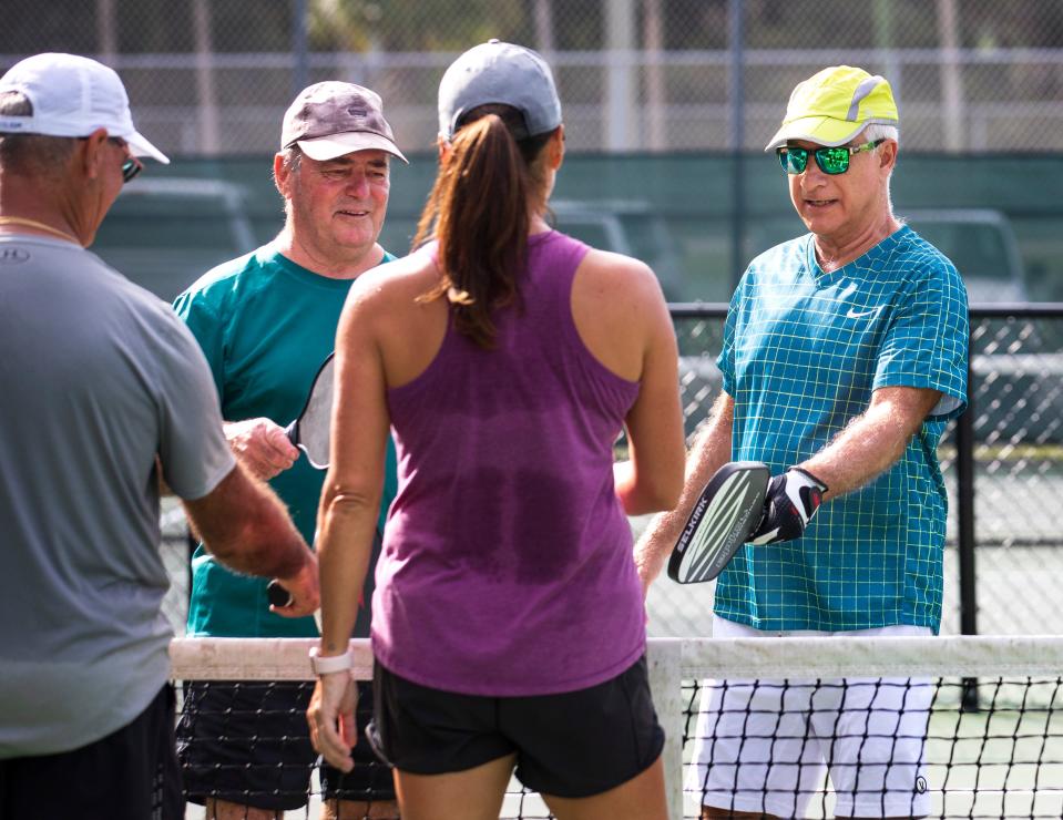 Frank Cerabino, right, talks with Chip Rogers, Jacque Castonguay and Paige Morris after a game of pickleball at the courts in Lake Lytal Park in West Palm Beach Tuesday, December 14, 2021. Frank has written a book about pickleball and his addiction to the sport.