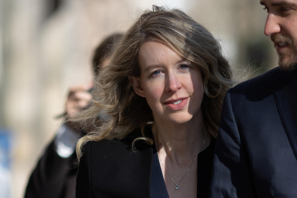 Theranos founder Elizabeth Holmes arrives at the federal courthouse accompanied by her partner Billy Evans, to ask a U.S. judge at a hearing to pause her prison sentence of more than 11 years while she urges an appeals court to review her conviction on charges of defrauding investors in the blood testing startup at the federal courthouse in San Jose, California, U.S., March 17, 2023. REUTERS/Carlos Barria