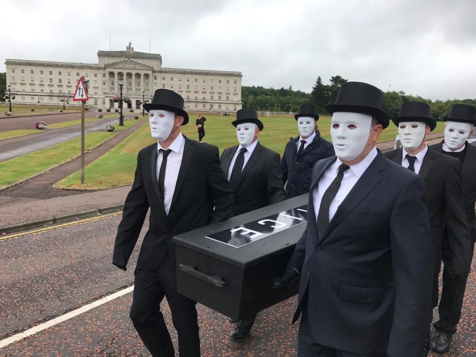 People take part in a staged funeral procession through the grounds of the Stormont estate (Jonathan McCambridge/PA) (PA Wire)