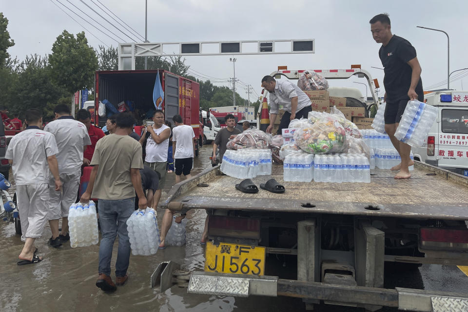 Residents unload supplies from a truck for evacuees from floods in Zhuozhou in northern China's Hebei province, south of Beijing, Wednesday, Aug. 2, 2023. China's capital has recorded its heaviest rainfall in at least 140 years over the past few days. Among the hardest hit areas is Zhuozhou, a small city that borders Beijing's southwest. (AP Photo/Andy Wong)