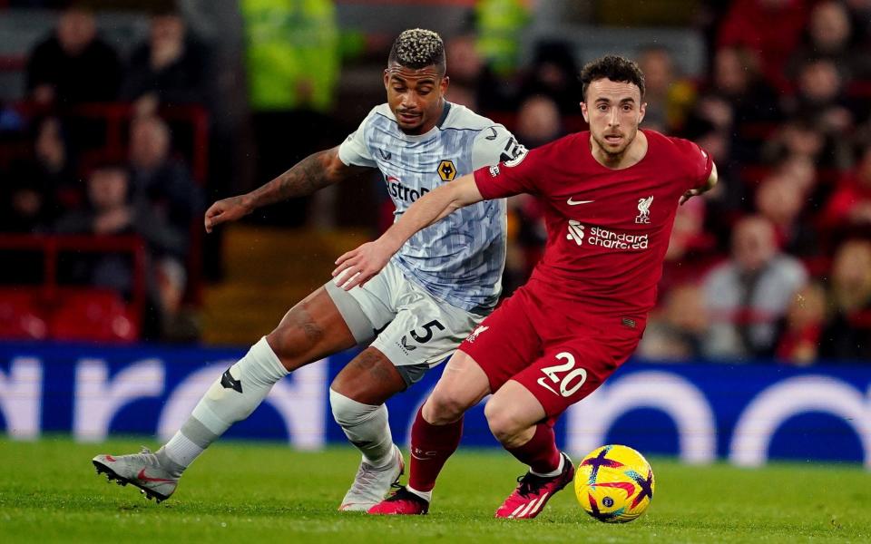 Liverpool's Diogo Jota and Wolverhampton Wanderers' Mario Lemina battle for the ball during the Premier League match at Anfield - Peter Byrne/PA Wire