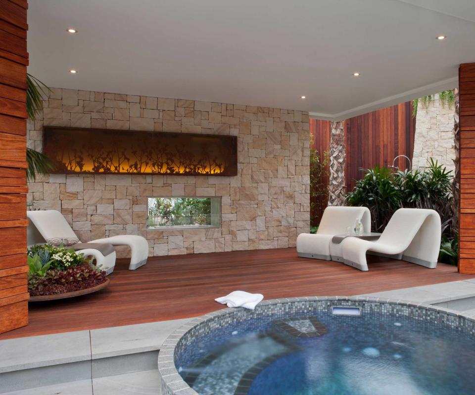 hot tub alongside covered outdoor living area