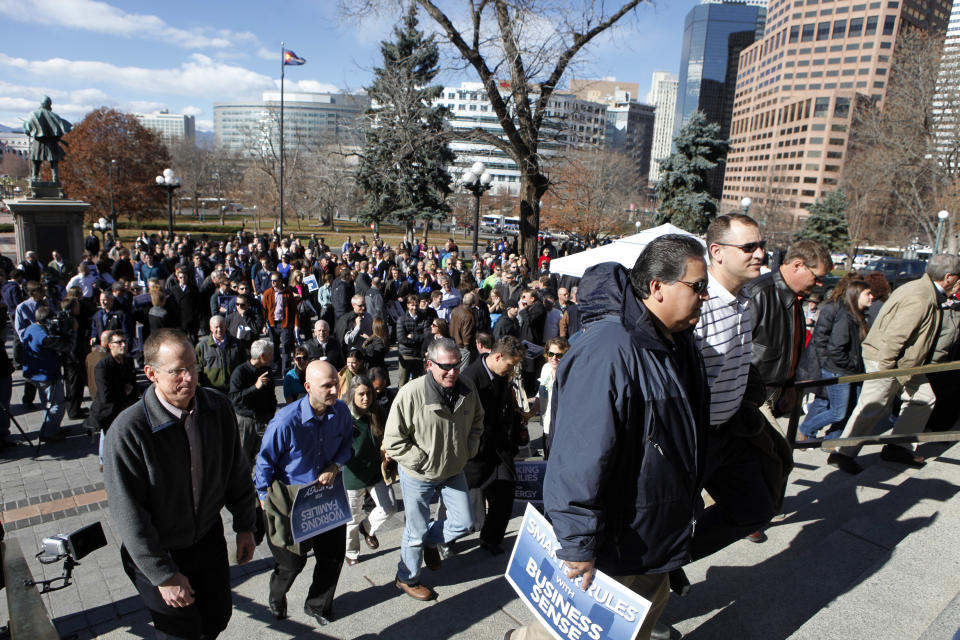 Supporters of fracking climb the steps for a rally at the Capitol in Denver on Tuesday, Nov. 13, 2012. The rally hosted by the greater Colorado business community was held to show support that oil and gas can and should be developed responsibly in Colorado. (AP Photo/Ed Andrieski)