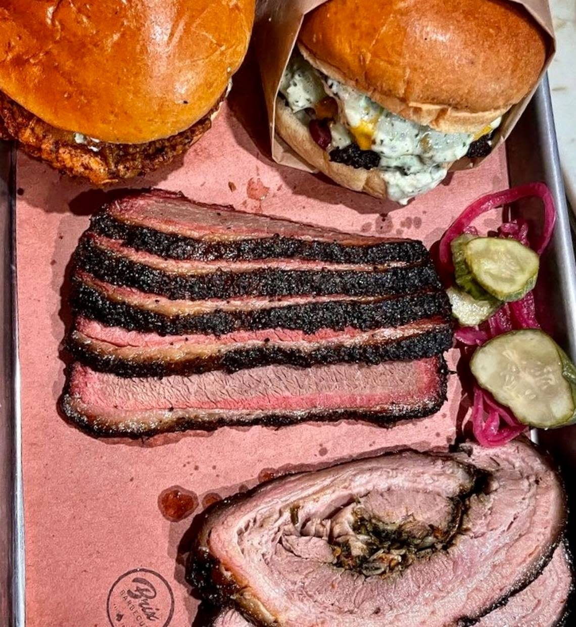 A hot chicken sandwich, burger, prime brisket and stuffed pork belly at Brix Barbecue in Fort Worth. Handout photo