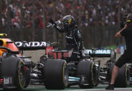 Mercedes' Lewis Hamilton greets fans at the end of a Sprint Race qualifying session at the Interlagos racetrack, in Sao Paulo, Brazil, Saturday, Nov.13, 2021. The Brazilian Formula One Grand Prix will take place on Sunday. (Lars Baron/Pool via AP)