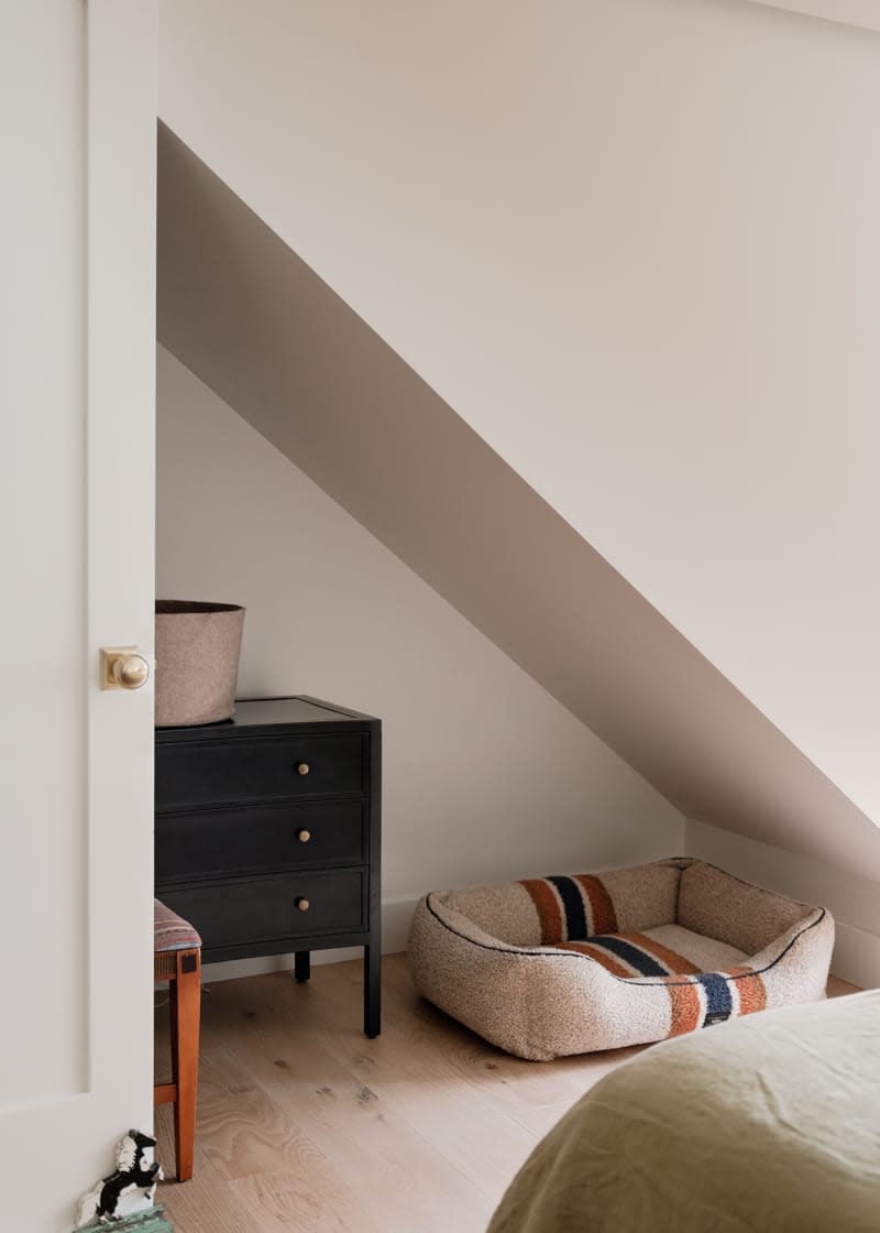 Dog bed in corner of bedroom.