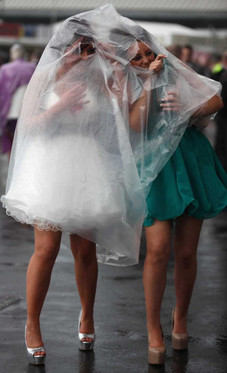 Racegoers brave the rain during Ladies Day at the Aintree Grand National. Friday is traditionally Ladies Day at the three-day event, where fashion and dressing to impress is as important as the racing.