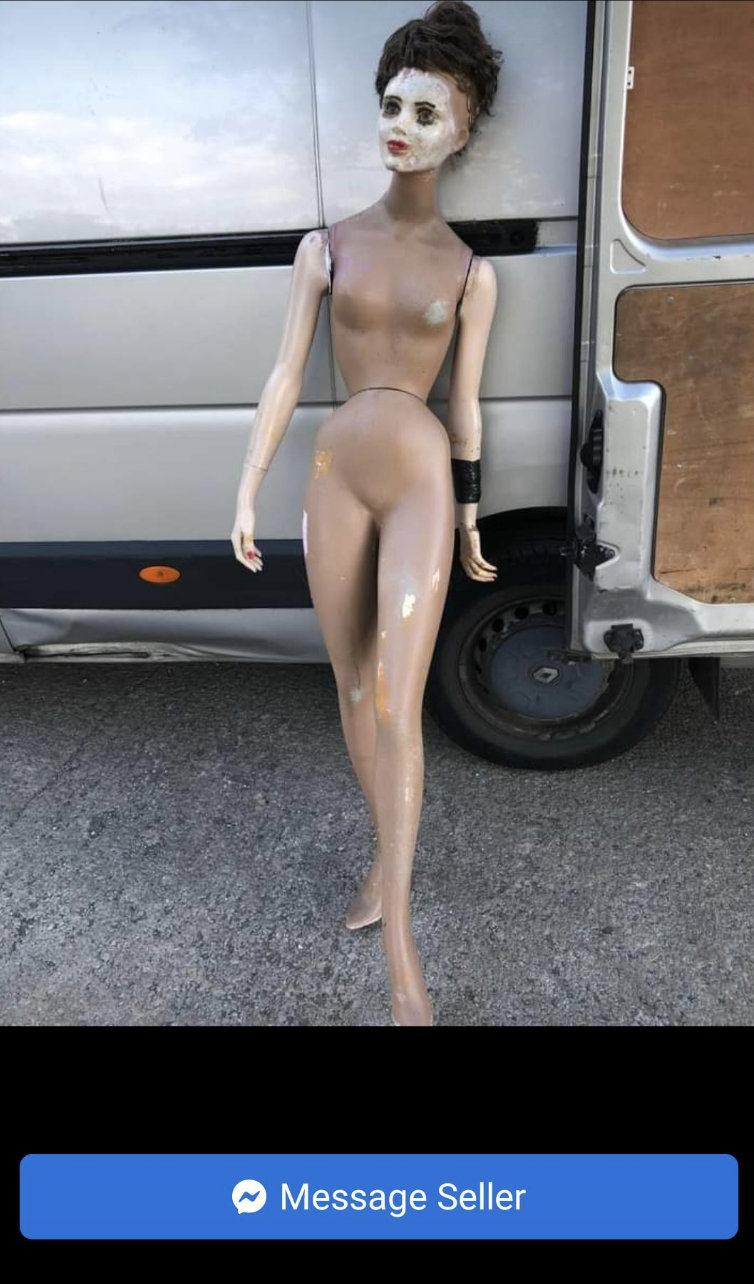 naked mannequin with mismatch arms and a messy top knot