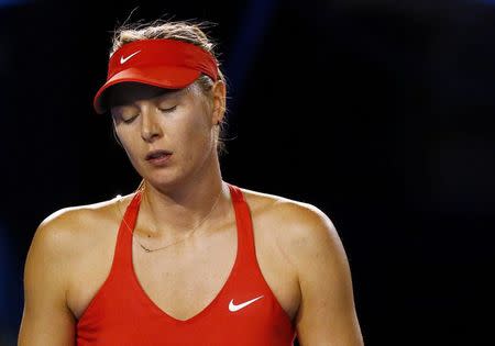 Maria Sharapova of Russia reacts after missing a shot against Serena Williams of the U.S. during their women's singles final match at the Australian Open 2015 tennis tournament in Melbourne January 31, 2015. REUTERS/Thomas Peter