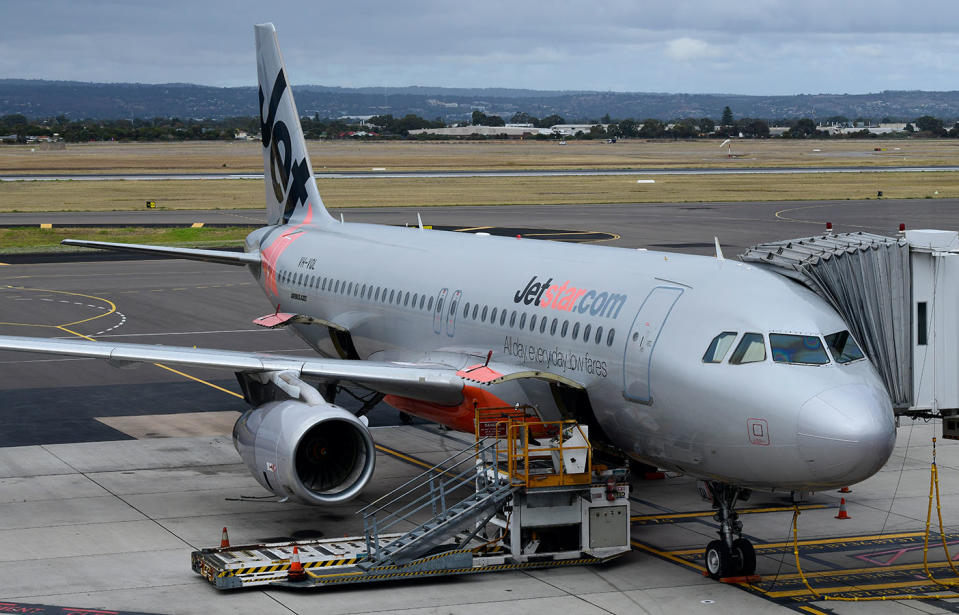 A Jetstar plane is seen on the airport tarmac.