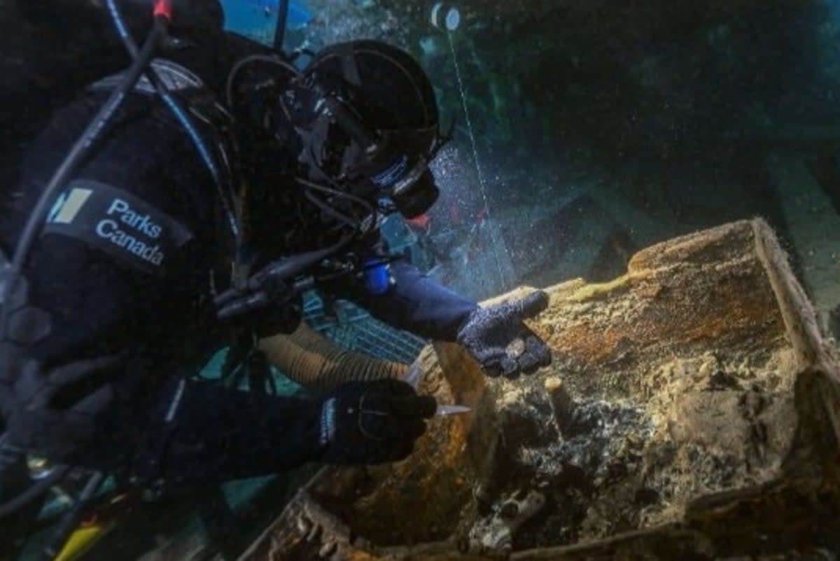 Underwater archaeologist Marc-André Bernier inspects a seamen’s chest on Erebus (Brett Seymour/Parks Canada)