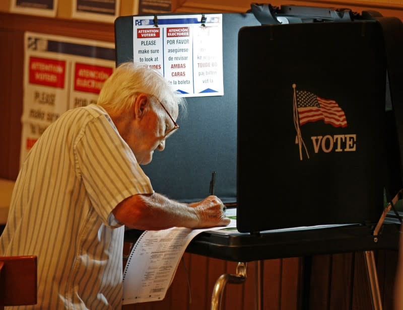 An unidentified voter casts his ballot at a local polling station in Miami