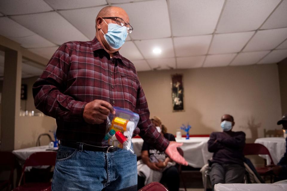 Uniontown resident Joe Williams shows the medicine he takes following the increase in waste specifically, coal ash, at the neighboring Arrowhead landfill during a community meeting in Uniontown, Ala., on Thursday, Feb. 10, 2022.