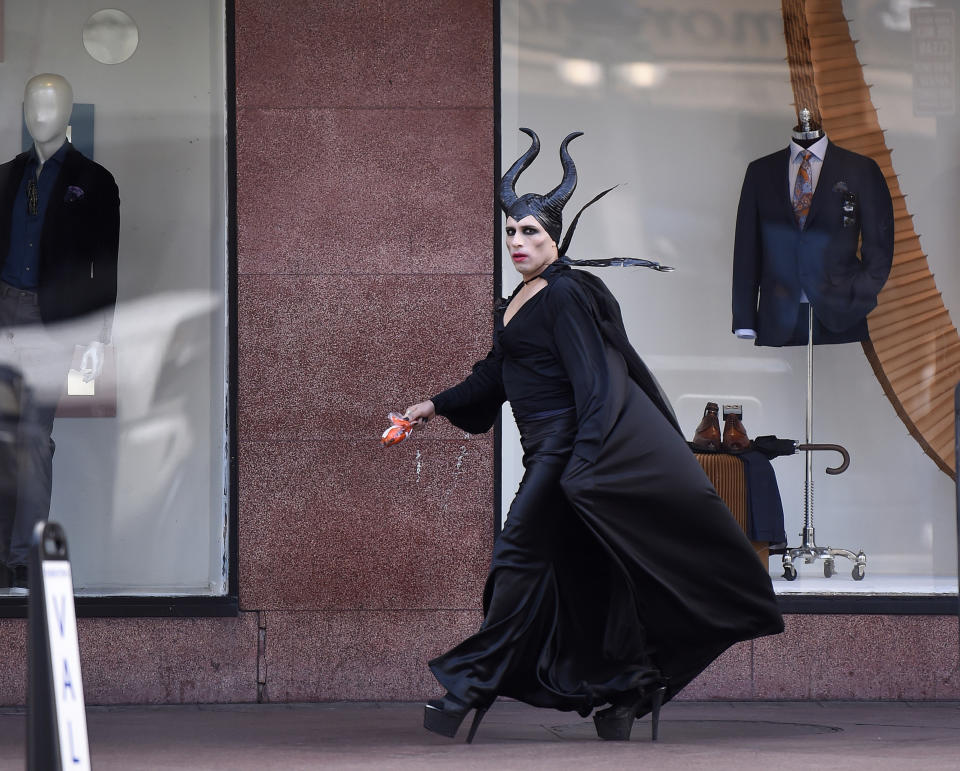 A cold wind blows against a Halloween reveler's costume on Canal Street in New Orleans, La. Thursday, Oct. 31, 2019. The U.S. National Weather Service issued a Wind Advisory 10:00 PM on Halloween. (Max Becherer/The Advocate via AP)