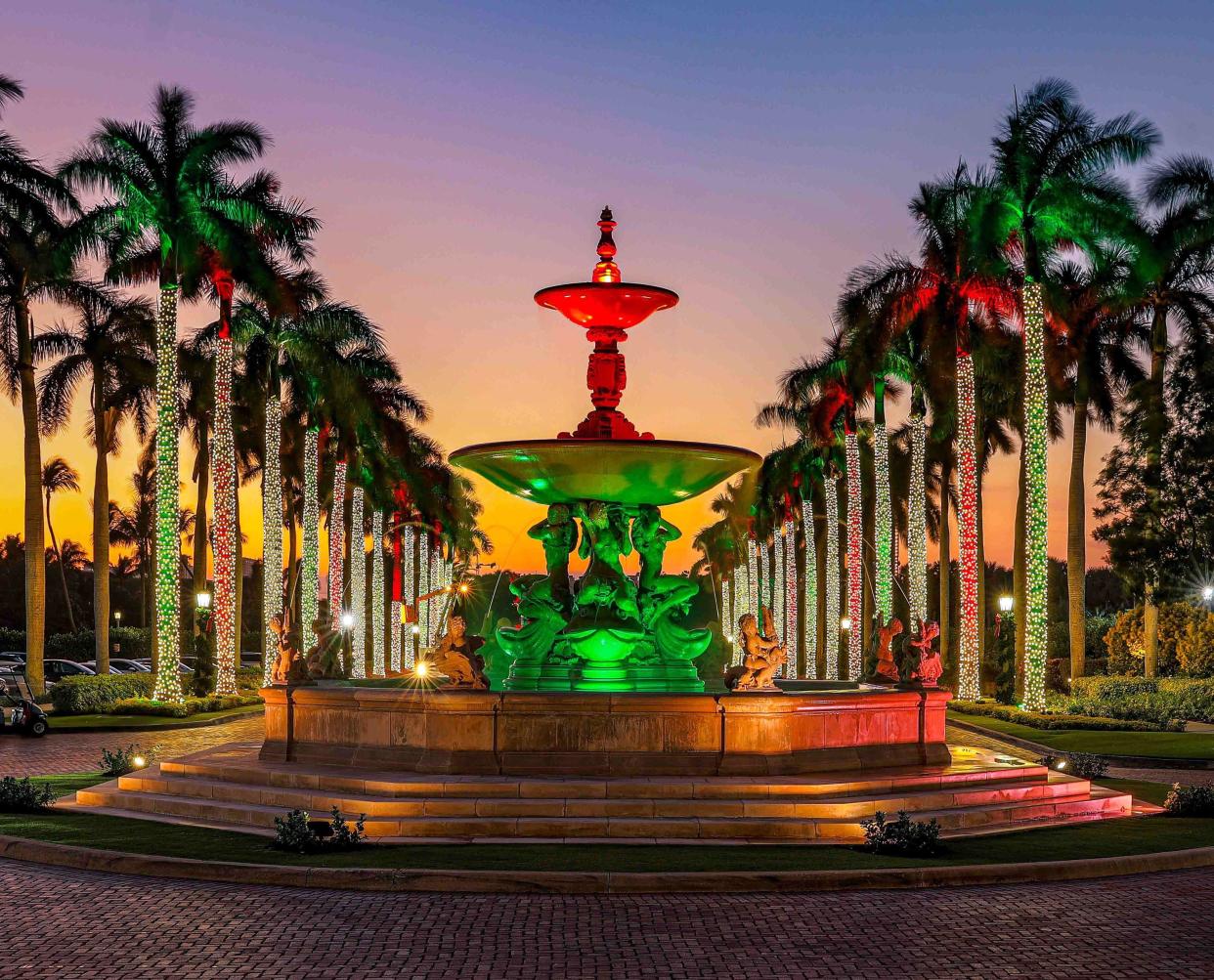 Vibrant holiday hues light up The Breakers' Florentine Fountain in December 2022.