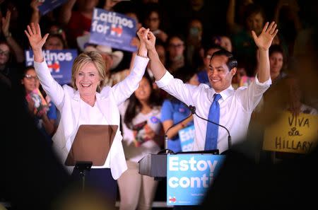Democratic U.S. presidential candidate Hillary Clinton waves with U.S. Secretary of Housing and Urban Development Julian Castro at her side during a "Latinos for Hillary" rally in San Antonio, Texas October 15, 2015. Castro endorsed Clinton's campaign for president. REUTERS/Darren Abate