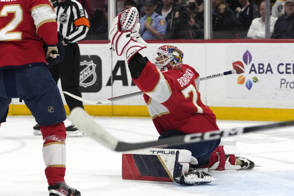 Florida Panthers goaltender Sergei Bobrovsky, right, makes a save during the second period of an NHL hockey game against the Buffalo Sabres, Saturday, April 13, 2024, in Sunrise, Fla. (AP Photo/Lynne Sladky)