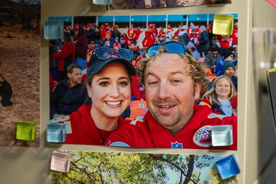 Elizabeth Brown displays a photo of her and her husband taken at a Kansas City Chiefs game in her office on Monday, Feb. 5, 2024, in Guymon, Okla.