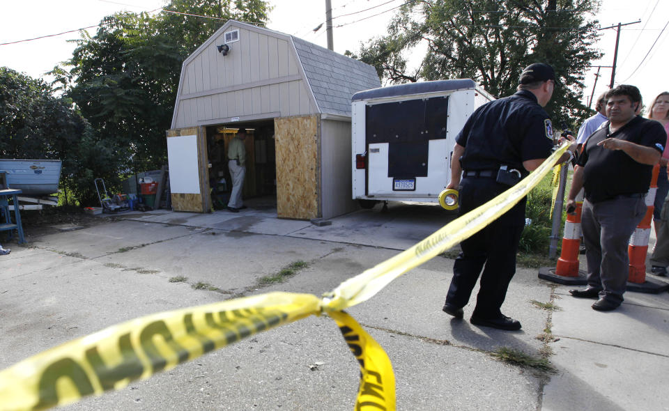 *FILE- In a Sept. 28, 2012 file photo, police tape blocks a driveway where authorities drilled for soil samples in the floor of a shed at a Roseville, Mich. Police were told by a source that former Teamsters boss Jimmy Hoffa may be buried beneath the driveway. The FBI's recent confirmation that it was looking at a spot near a New Jersey landfill as the possible burial site of former Teamsters boss Jimmy Hoffa is the latest development in a search that began when he disappeared in 1975. (AP Photo/Paul Sancya, File)