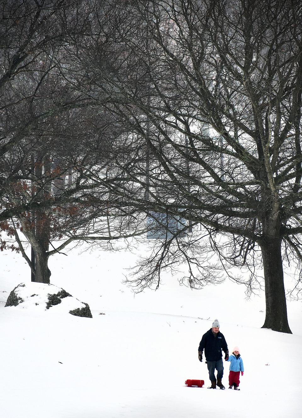 Steven Cox and daughter Adeline walk up lower Kennedy park Friday.