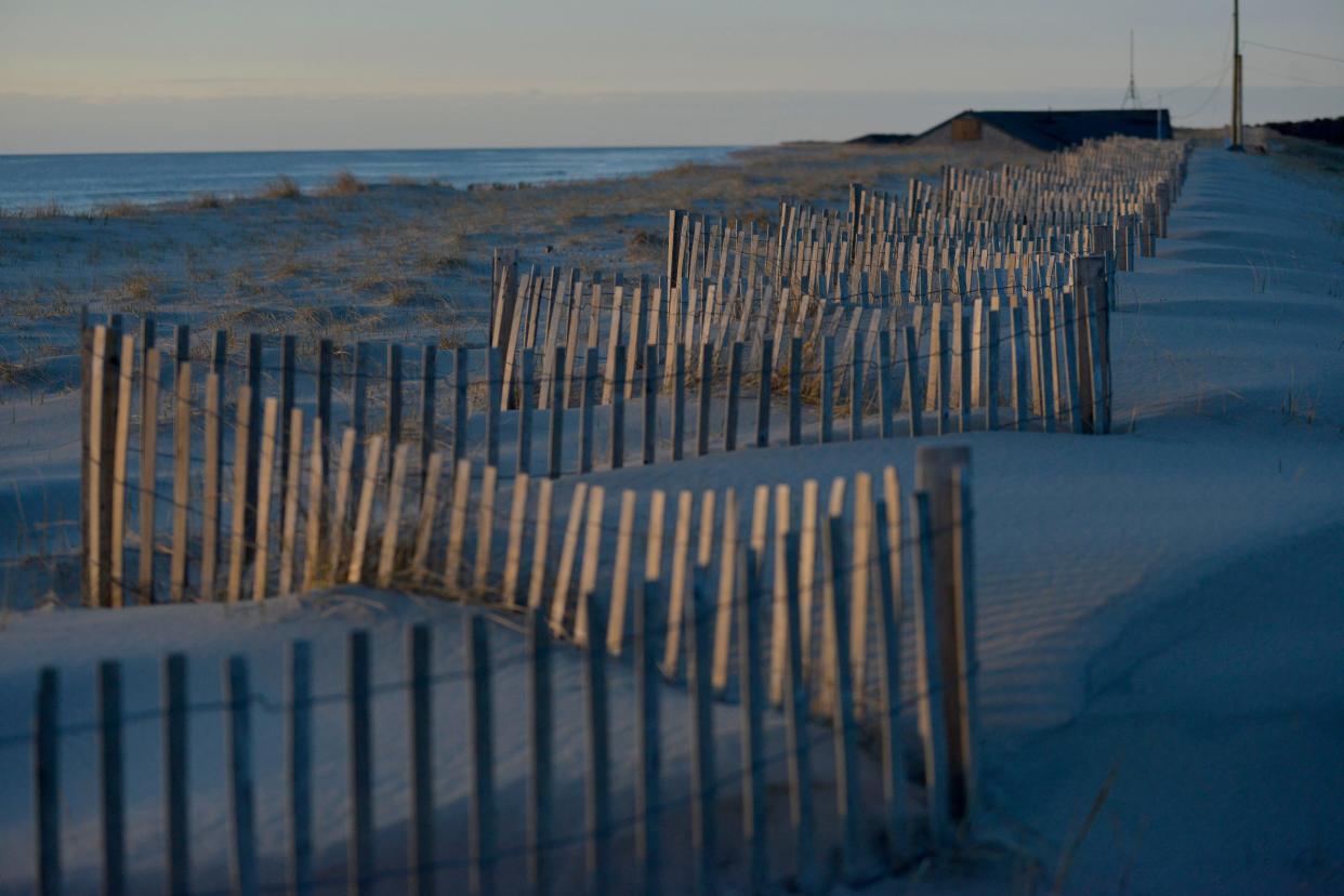 The early morning sun rises over Nauset Beach, in Orleans on March 31.