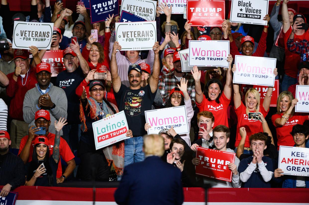 President Donald Trump claps with supporters during a rally at the North Charleston Coliseum Friday, Feb. 28, 2020.