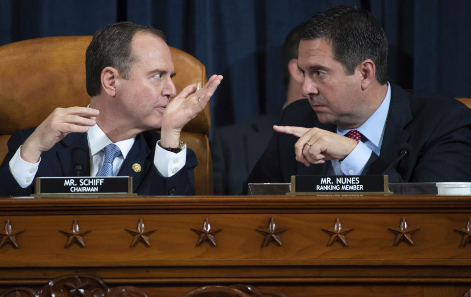 House Intelligence Committee Chairman Rep. Adam Schiff, D-Calif., left, talks with ranking member Rep. Devin Nunes, R-Calif., during a hearing of the House Intelligence Committee on Capitol Hill in Washington, Wednesday, Nov. 13, 2019, during the first public impeachment hearing of President Donald Trump's efforts to tie U.S. aid for Ukraine to investigations of his political opponents. (Saul Loeb/Pool Photo via AP)