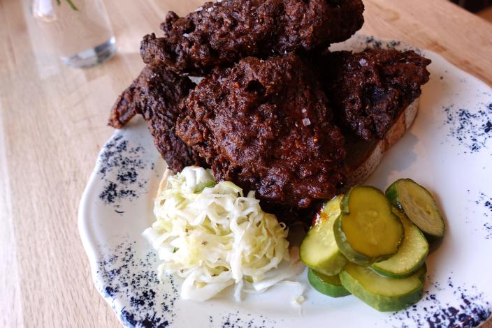 Nashville hot chicken with slaw and pickles at The Larder + The Delta in Phoenix, AZ.