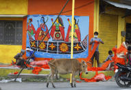 Workers decorate one of the main street as part of preparations for the groundbreaking ceremony of a temple to the Hindu god Ram in Ayodhya, in the Indian state of Uttar Pradesh, Monday, Aug. 3, 2020. As Hindus prepare to celebrate the groundbreaking of a long-awaited temple at a disputed ground in northern India, Muslims say they have no firm plans yet to build a new mosque at an alternative site they were granted to replace the one torn down by Hindu hard-liners decades ago. (AP Photo/Rajesh Kumar Singh)