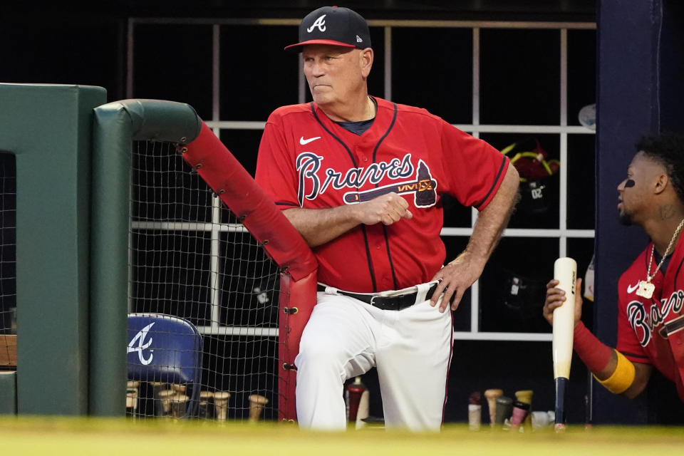 Atlanta Braves manager Brian Snitker watches from the dugout as the team plays against the Pittsburgh Pirates in a baseball game Friday, June 10, 2022, in Atlanta. (AP Photo/John Bazemore)