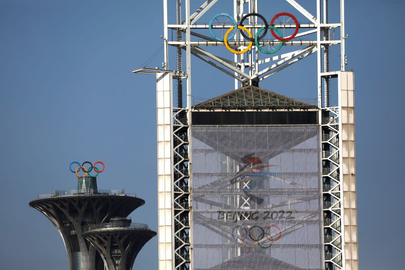 Olympic rings and a sign of 2022 Winter Olympic Games, are seen at the Beijing Olympic Green in Beijing