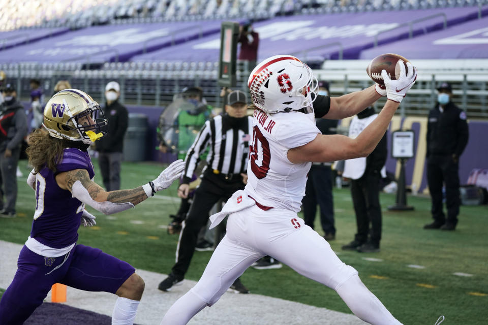 Stanford tight end Scooter Harrington, right, catches a touchdown pass as Washington's Asa Turner trails him in the second half of an NCAA college football game Saturday, Dec. 5, 2020, in Seattle. (AP Photo/Elaine Thompson)