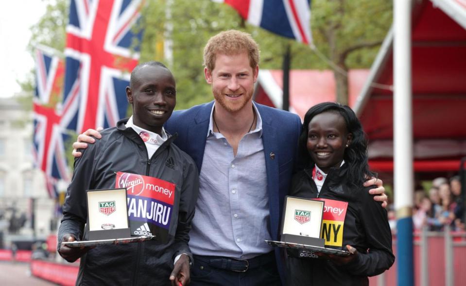 Winners: Prince Harry poses with the winner of the men's elite race, Kenya's Daniel Wanjiru and the winner of the momen's race, Kenya's Mary Keitany(PA)