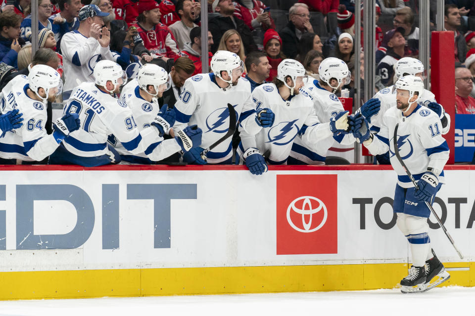 Tampa Bay Lightning center Luke Glendening (11) celebrates with teammates after scoring during the first period of an NHL hockey game against the Washington Capitals, Saturday, Dec. 23, 2023, in Washington. (AP Photo/Stephanie Scarbrough)