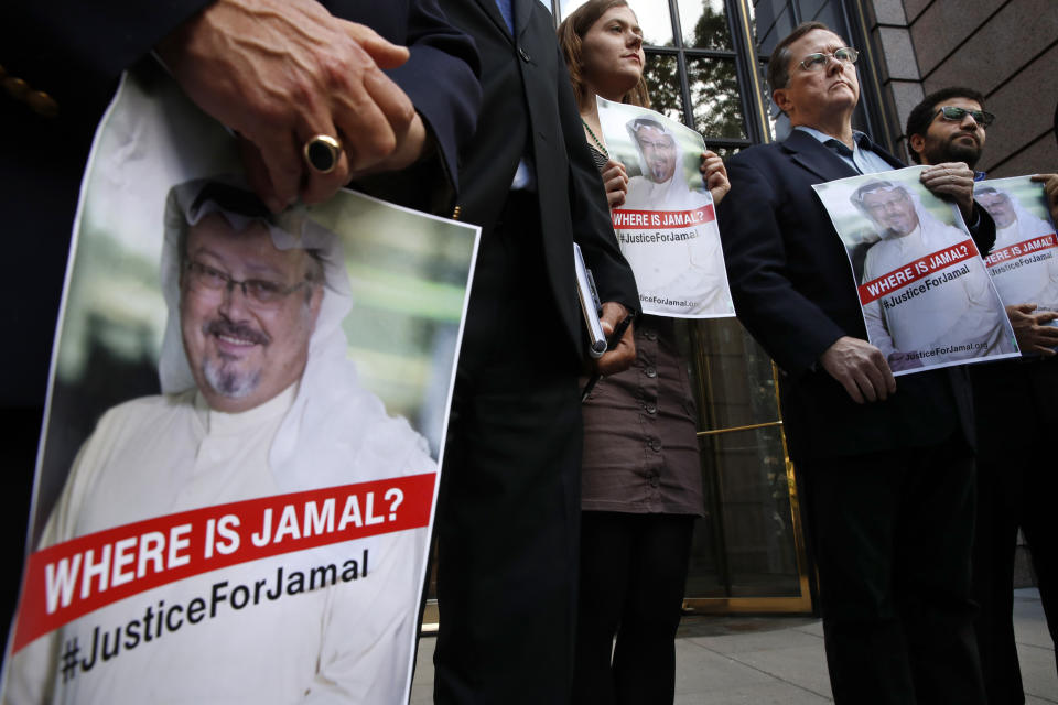 Alyssa Edling, center, and Thomas Malia, second from right, both with PEN America, join others as they hold signs of missing journalist Jamal Khashoggi, during a news conference about his disappearance in Saudi Arabia, Wednesday, Oct. 10, 2018, in front of The Washington Post in Washington. (AP Photo/Jacquelyn Martin)